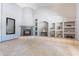 Cozy living room featuring a tiled fireplace and built-in shelving at 5127 W Dobbins Rd, Laveen, AZ 85339