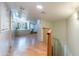 Upstairs landing with hardwood floors, built-in window seat, and natural light streaming in at 5127 W Dobbins Rd, Laveen, AZ 85339