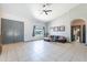 Bright living room with neutral tones, tile floors, vaulted ceiling, and a comfortable gray sofa at 5127 W Dobbins Rd, Laveen, AZ 85339