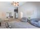 Bright, carpeted primary bedroom with bean bag chairs, neutral decor, and a ceiling fan at 5127 W Dobbins Rd, Laveen, AZ 85339