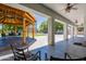 View of an expansive outdoor space, showcasing a well-designed wooden pergola, seating area, and manicured lawn at 5127 W Dobbins Rd, Laveen, AZ 85339