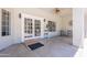 Spacious outdoor patio featuring tile flooring, ceiling fan, and access to the backyard through glass panel doors at 5127 W Dobbins Rd, Laveen, AZ 85339