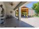 Covered patio with decorative ceiling fan provides shade and style, offering views of the gazebo and backyard at 5127 W Dobbins Rd, Laveen, AZ 85339
