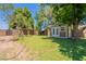 Backyard shed with white trim, double doors, and landscaping at 5127 W Dobbins Rd, Laveen, AZ 85339