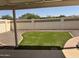 View of the backyard that features artificial grass and a stone border within a block wall at 6233 E Pinchot Ave, Scottsdale, AZ 85251
