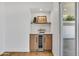 Stylish bar area with a built-in wine fridge, custom cabinets, and a convenient countertop at 6233 E Pinchot Ave, Scottsdale, AZ 85251
