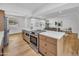 Spacious kitchen with stainless steel appliances, an island, and an adjacent living space for seamless entertaining at 6233 E Pinchot Ave, Scottsdale, AZ 85251