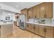 Open kitchen with stainless steel appliances, quartz counters, and ample cabinet space in a bright, airy setting at 6233 E Pinchot Ave, Scottsdale, AZ 85251