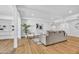 Spacious, modern living room with wood floors, contemporary furnishings, and access to built-in shelving at 6233 E Pinchot Ave, Scottsdale, AZ 85251