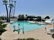 View of the swimming pool and surrounding palm trees with chairs and shade for residents to enjoy at 6233 E Pinchot Ave, Scottsdale, AZ 85251