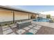 Backyard with a fireplace, pool, pavers, and turf is the perfect place to relax at 6401 E Larkspur Dr, Scottsdale, AZ 85254
