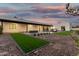 Charming backyard featuring a pool, manicured lawn, sleek modern design, and inviting fire features at 6401 E Larkspur Dr, Scottsdale, AZ 85254