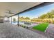 An inviting backyard with pavers, swimming pool, lush landscaping and an outdoor grill at 6401 E Larkspur Dr, Scottsdale, AZ 85254