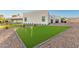 Well-maintained backyard with a putting green and mature landscaping enhances the outdoor living experience at 6401 E Larkspur Dr, Scottsdale, AZ 85254