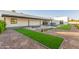 Well maintained backyard with a fireplace, pool, pavers, and artificial turf at 6401 E Larkspur Dr, Scottsdale, AZ 85254