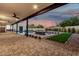 Large covered patio overlooking a backyard with a swimming pool and firepit at 6401 E Larkspur Dr, Scottsdale, AZ 85254