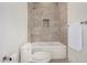 Modern bathroom featuring a bathtub with tile surround and a sleek toilet at 6401 E Larkspur Dr, Scottsdale, AZ 85254