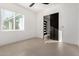 Minimalist bedroom with a ceiling fan, modern tile floor, and a large window at 6401 E Larkspur Dr, Scottsdale, AZ 85254