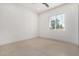 Minimalist bedroom with light tile flooring and a window at 6401 E Larkspur Dr, Scottsdale, AZ 85254