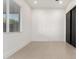 Clean bedroom featuring a window and black sliding closet doors and neutral-colored flooring at 6401 E Larkspur Dr, Scottsdale, AZ 85254