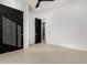 Bedroom featuring a black sliding door and a glimpse of an ensuite bathroom at 6401 E Larkspur Dr, Scottsdale, AZ 85254