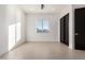 Sunlit bedroom featuring a window and a closet with black doors and neutral-colored flooring at 6401 E Larkspur Dr, Scottsdale, AZ 85254