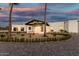 Single-story desert home featuring desert landscaping, porte cochere, and three-car garage at 6401 E Larkspur Dr, Scottsdale, AZ 85254