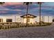 Modern single-story desert home featuring a porte cochere, a three-car garage, and landscaping at 6401 E Larkspur Dr, Scottsdale, AZ 85254
