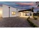 Modern home with a three-car garage, porte cochere, and modern architectural design at 6401 E Larkspur Dr, Scottsdale, AZ 85254