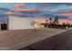 Modern desert home with a three-car garage, covered porte cochere, and desert landscaping at 6401 E Larkspur Dr, Scottsdale, AZ 85254