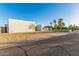 Modern home with a flat roof, desert landscaping, and a porte cochere, blending contemporary design with natural surroundings at 6401 E Larkspur Dr, Scottsdale, AZ 85254