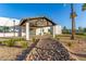 Beautiful modern home showcasing desert landscaping, and stylish covered entryway with natural rock feature at 6401 E Larkspur Dr, Scottsdale, AZ 85254