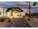 Stunning home exterior featuring a porte cochere, desert landscaping, and a modern white facade under a colorful sky at 6401 E Larkspur Dr, Scottsdale, AZ 85254