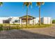 Elegant modern home with palm trees and a circular driveway, enhancing curb appeal and providing a luxurious feel at 6401 E Larkspur Dr, Scottsdale, AZ 85254