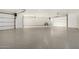 Spacious 3-car garage with epoxy flooring and overhead doors, ready for your vehicles at 6401 E Larkspur Dr, Scottsdale, AZ 85254