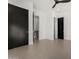 Hallway featuring multiple black interior doors and neutral-colored flooring at 6401 E Larkspur Dr, Scottsdale, AZ 85254