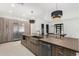 Modern kitchen features a large island, stainless steel appliances, and stylish pendant lighting at 6401 E Larkspur Dr, Scottsdale, AZ 85254