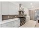 Close up of kitchen featuring a stainless steel range hood, cooktop, and sleek cabinetry at 6401 E Larkspur Dr, Scottsdale, AZ 85254