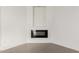 Close-up of a modern electric corner fireplace against a white wall with tile flooring at 6401 E Larkspur Dr, Scottsdale, AZ 85254