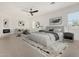Spacious main bedroom featuring a comfortable seating area, ceiling fan, and natural light at 6401 E Larkspur Dr, Scottsdale, AZ 85254