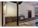 Outdoor kitchen area with built-in grill and storage under a shaded pergola at 6401 E Larkspur Dr, Scottsdale, AZ 85254
