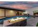 Captivating pool featuring a built-in fire feature, seamless access to the patio, and desert landscaping at 6401 E Larkspur Dr, Scottsdale, AZ 85254