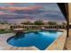 Lovely backyard showcases pool with lit fire features and adjacent yard at 6401 E Larkspur Dr, Scottsdale, AZ 85254