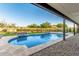 Relaxing pool features manicured landscaping and stone accents offering a resort-like backyard at 6401 E Larkspur Dr, Scottsdale, AZ 85254
