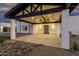 Well-lit porte cochere featuring a modern door and ample parking space, offering a luxurious arrival experience at 6401 E Larkspur Dr, Scottsdale, AZ 85254