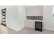 Elegant wet bar area featuring modern cabinets, a sink, and a wine refrigerator at 6401 E Larkspur Dr, Scottsdale, AZ 85254