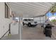 Carport featuring a vehicle, washing machine, grill, and shaded parking area for convenience at 701 S Dobson Rd # 438, Mesa, AZ 85202