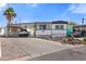 Charming mobile home with covered parking, landscaped yard, and a patriotic decorative banner at 701 S Dobson Rd # 438, Mesa, AZ 85202