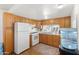 Functional kitchen featuring white appliances, wood cabinets, and laminate countertops at 701 S Dobson Rd # 438, Mesa, AZ 85202