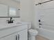 Bathroom featuring a white vanity, toilet, and a tub-shower combo with black fixtures at 7448 S 75Th Ln, Laveen, AZ 85339